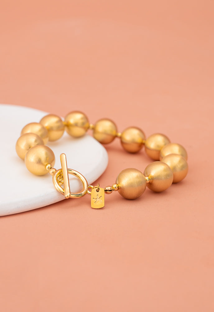 Ball Bracelet in Gold, Gives Freedom to Exploited Women!