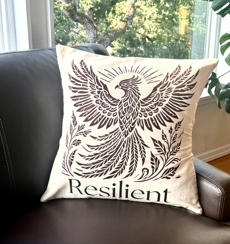 20" x 20" Decorative cotton Canvas pillow with a Rising Phoenix design and the word 'Resilient'. Hand-sewn & Hand-printed by Women Survivors in Kolkata, India. 