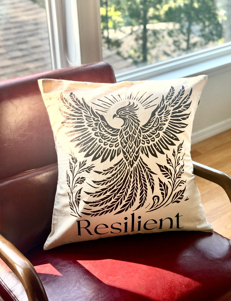 20" x 20" Decorative cotton Canvas pillow with a Rising Phoenix design and the word 'Resilient'. Hand-sewn & Hand-printed by Women Survivors in Kolkata, India. 